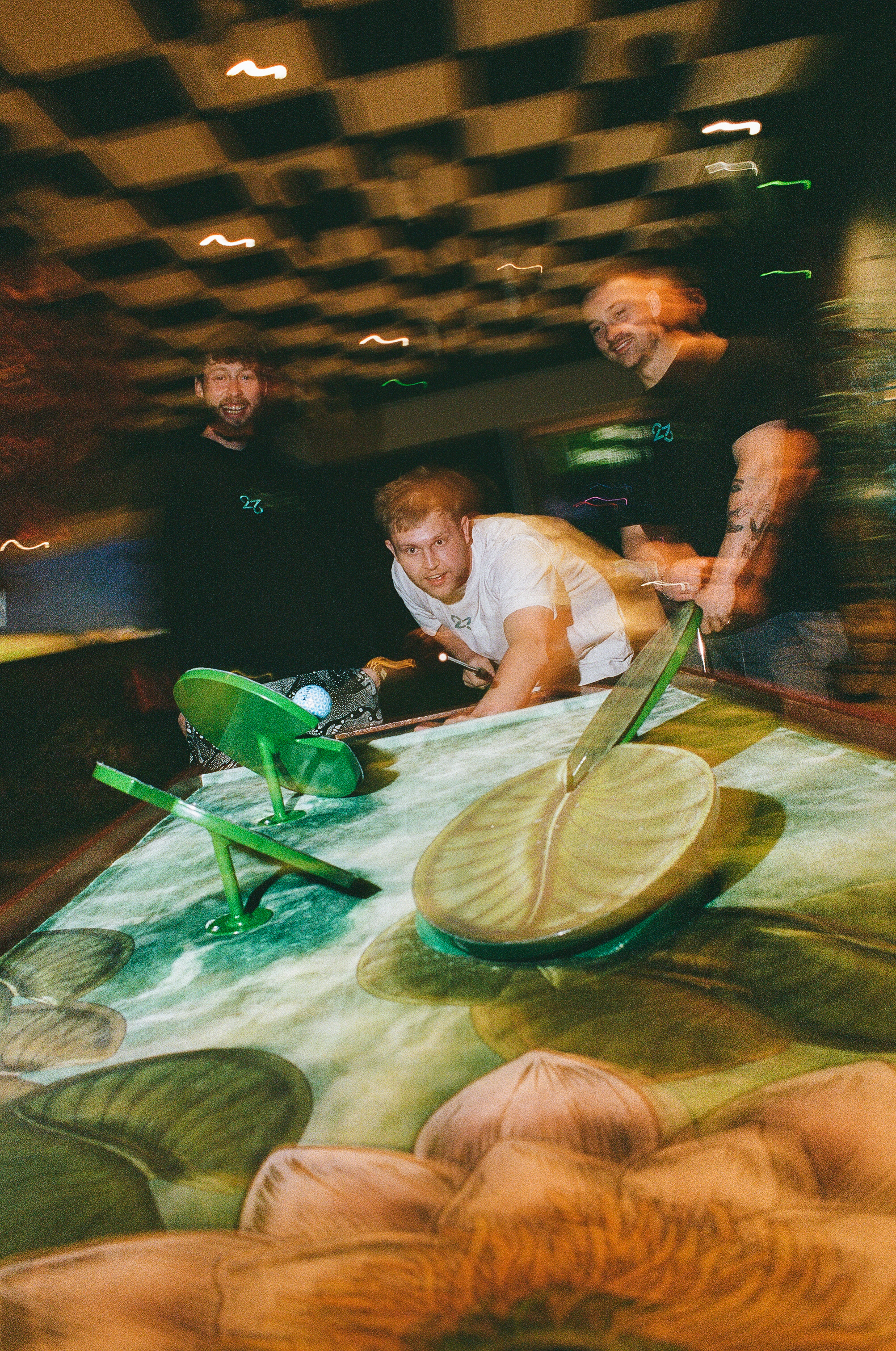 Players at Cue Golf tables